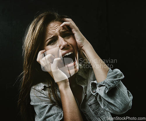 Image of Portrait, mental health and horror with woman screaming in studio on black background for reaction to fear. Face, anxiety and stress with scared young person in dark for drama, nightmare or terror