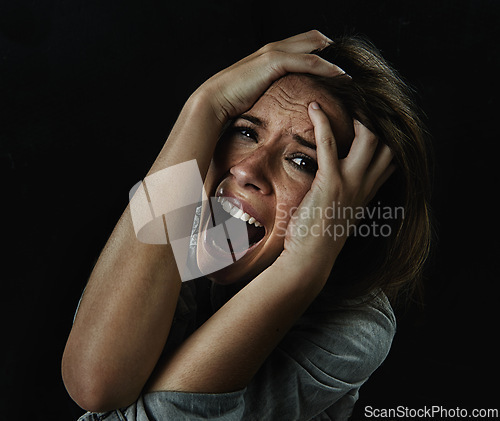 Image of Portrait, horror and fear with woman screaming in studio on black background for reaction to danger. Face, stress and mental health with scared young person in dark for phobia, nightmare or terror