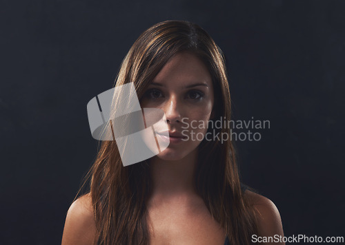 Image of Woman, haircare and gloss for portrait in studio, cosmetics and satisfaction for keratin treatment on black background. Female person, transformation and pride for dermatology, confidence and growth