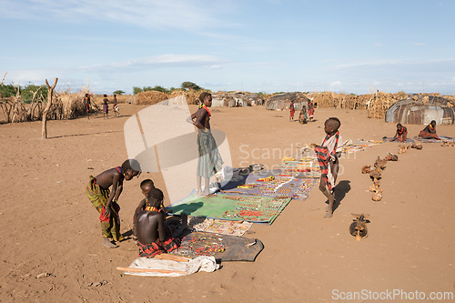 Image of Dasanesh children offering handmade souvenirs, Omorate, Omo Valley, Ethiopia