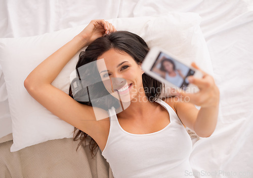 Image of Woman, selfie and above in bedroom to relax on vacation, hotel or photography for web blog in morning. Girl, person and influencer for profile picture, home and live streaming in bed on social media