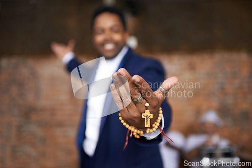 Image of Black man, christianity and hands with cross at church for holy welcome, faith or hope of spiritual leader. Closeup of African male person, priest or preacher with rosary beads for worship of god