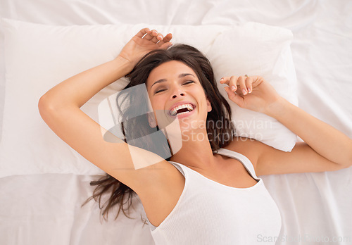 Image of Laughing, relax or above of woman in bed for resting in pyjamas to wake up alone in home. Morning, calm or top view of excited female person on break or pillow with smile, ready to start day or chill