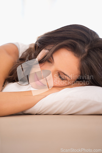 Image of Relax, bed and woman sleeping for peace or resting in a house or home dreaming with a pillow. Calm lady, morning routine or tired female person in bedroom alone for nap, wellness or health on weekend