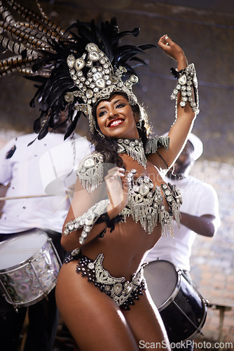 Image of Carnival, dancing and woman for performance in Brazil, dancer with gemstone outfit and feather head gear outdoor. Music, samba and happiness for event, culture with festival entertainment and talent