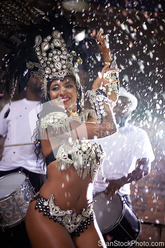 Image of Carnival, woman and dancing in street with confetti and performance in Brazil, costume and feather head gear outdoor. Music, samba and happy for event, culture with festival entertainment and talent