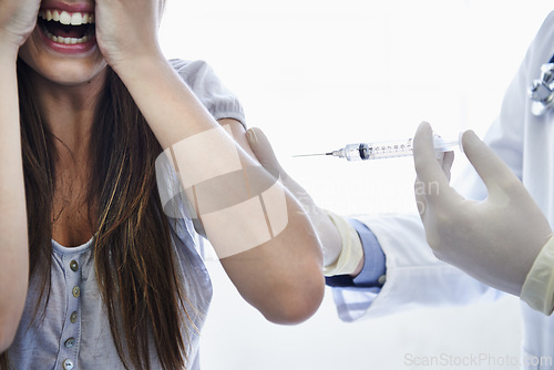 Image of Patient, doctor and syringe injection with fear, scream or needle for flu vaccination, trypanophobia or healthcare. Medical worker, woman and shot in arm for disease protection, scared or treatment