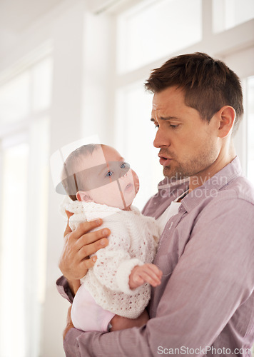 Image of Father, care and newborn baby with love, support and console for family on paternity. Dad, single parent or man helping his child or infant with development, growth and bonding or nurture at home