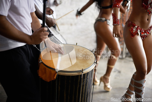 Image of Drummer, playing and music with percussion by stage, dancers and rhythm of artist with talent in band. Brazilian people, samba or performing in group as professional musician or costume for live show