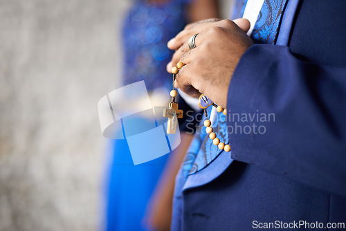 Image of Man, hands and christianity with cross for religion, belief or praying of priest or preacher at church. Closeup of male person, christian or religious person with rosary beads for tradition or ritual