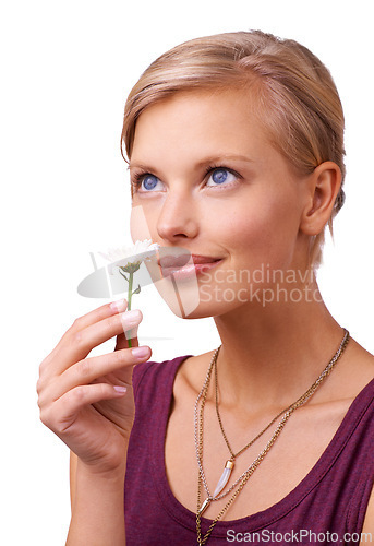 Image of Studio, young woman and smelling a flower on white background for scent of perfume for botanicals. Model, thinking or creative inspiration with daisy for stress relief or happy idea with floral plant