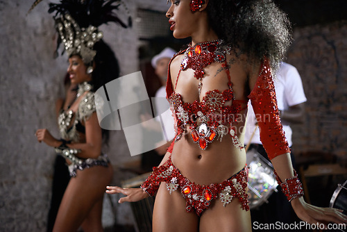 Image of Woman, samba dancer and friends in performance with costume for tradition at carnival or festival. Brazilian female person, exotic performer and band for culture or dancing at party or concert in Rio