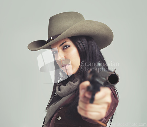 Image of Woman, cowgirl and portrait or pointing weapon for wild west costume on white background, rodeo or outfit. Female person, revolver and cowboy hat in studio for Texas dress up, confidence or mockup