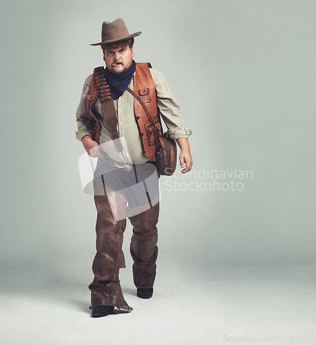 Image of Portrait, serious and criminal cowboy in studio mockup, outlaw and wild west character with pistol. Overweight texas man, bandit face or gun belt for fighting, western or cigar by white background