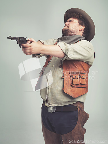 Image of Cowboy, western man and shooting gun, weapon and pistol in studio with costume isolated on a white background. Plus size, criminal and male person with revolver, aim and scared with fear in Texas