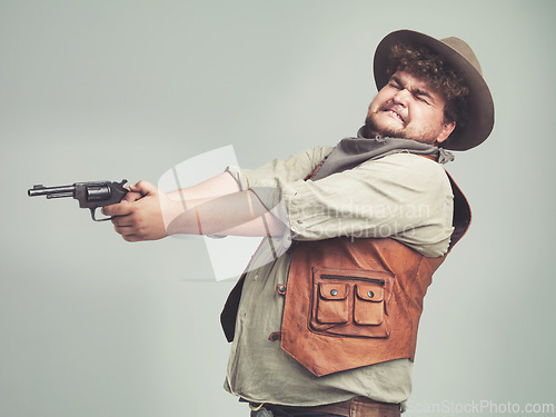 Image of Cowboy, funny man and shooting gun in studio, weapon and pistol for western fight isolated on a white background. Plus size, criminal and person with revolver, scared or guess aim with fear in Texas