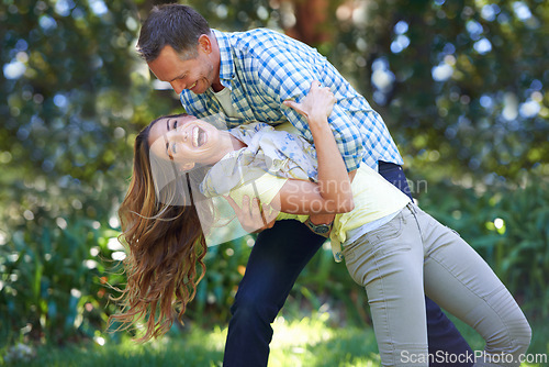 Image of Love, smile and playful couple in park for summer fun and outdoor date together in nature. Romance, mature man and happy woman in garden with morning sunshine, playing and marriage bonding in trees.