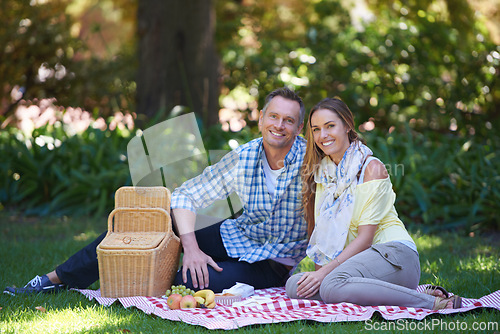 Image of Portrait, picnic and couple with love, basket and happiness with romance and Valentines day with marriage. Date, man and woman on the ground, relationship or anniversary with celebration or honeymoon