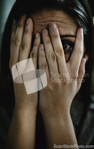 Image of Portrait, horror and hands on face of woman to cover reaction from fear, panic or terror closeup. Anxiety, stress and mental health with scared young person hiding from danger, drama or violence