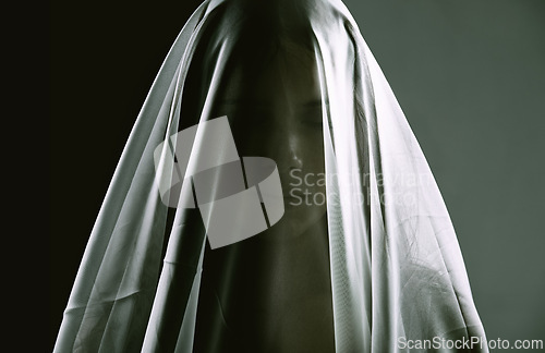 Image of Woman, veil and person as ghost, spirit and surreal for scary, death and horror on dark background. Creepy, dramatic and female silhouette as spiritual for halloween, witchcraft and terror in studio