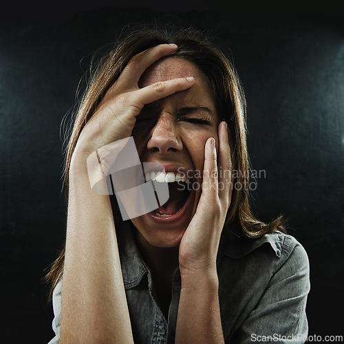 Image of Face, stress and horror with woman screaming in studio on black background for reaction to fear. Phobia, anxiety and mental health with scared young person in dark for drama, nightmare or terror