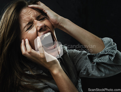 Image of Face, stress and horror with woman yelling in studio on black background for reaction to fear. Phobia, mental health and breakdown with scared young person in dark for drama, nightmare or terror