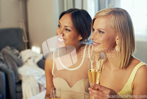 Image of Young women, champagne and celebration in hotel room as friends, support and fashion to celebrate engagement. Ladies night, bedroom and bubbly glass in elegant clothes and bonding for party event