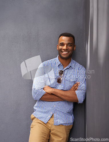 Image of Man, smile and cool fashion in portrait by wall background, style and gen z outfit in outdoors. Happy black male person, university student and pride for aesthetic, confident and trendy clothes