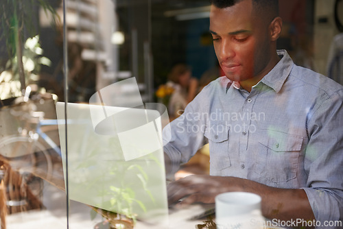 Image of Freelancer, internet and man with laptop at cafe for remote work, communication and networking. Black person, restaurant and web design with computer for planning, typing email or online research