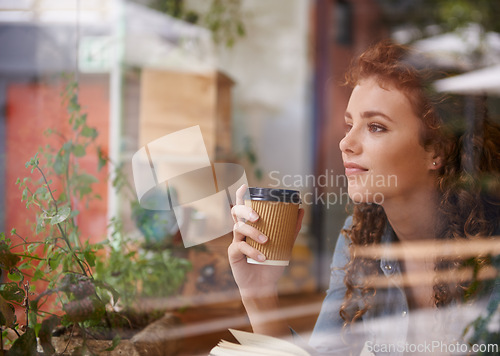 Image of Woman, coffee and thinking by window in cafe with book for creative idea, reading inspiration and knowledge. Person, freelancer and thoughtful with beverage in diner for research motivation and study