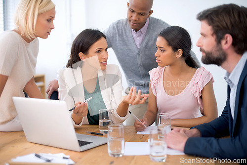 Image of Team, laptop and business people training with leader, planning or brainstorming in creative startup. Group, computer and mentor coaching diverse employees, interns and serious designers in meeting