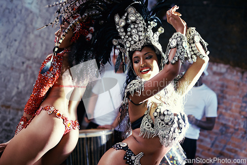Image of Party, carnival or women in costume dancing for celebration, music culture or samba in Brazil. Girl friends, smile or dancers with rhythm or fashion at festival, parade or fun show in Rio de Janeiro