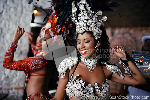 Image of Samba, festival and women in costume together for celebration, music culture and happy band in Brazil. Dance, party and girl friends with smile at carnival, parade or stage show in Rio de Janeiro