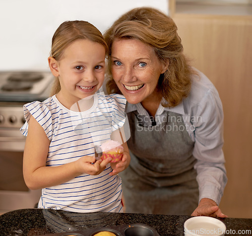 Image of Portrait, baking and girl with grandmother in kitchen of home for growth, learning or child development. Family, smile and cupcake with senior woman teaching granddaughter how to bake in apartment