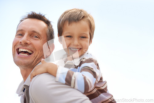 Image of Father, son and piggyback in portrait on vacation, bonding and playful by blue sky on summer holiday. Daddy, child and carrying game for fun, nature and support on adventure and laughing on weekend