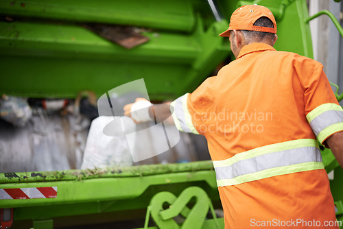 Image of Man, garbage truck and dirt collection on street or recycling pollution for waste management, cleaning or environment. Male person, back and refuse transportation in New York, service or maintenance