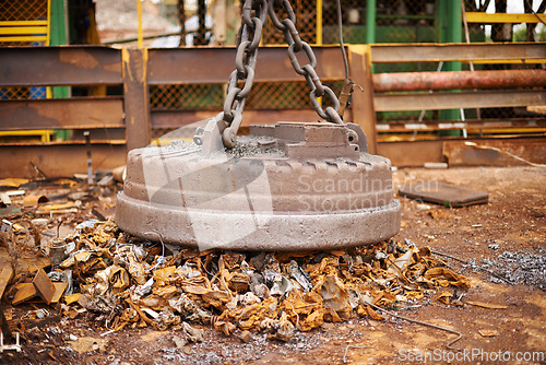 Image of Recycle, metal and rust on magnet in junkyard for sorting, garbage and scrap reuse at landfill site. Steel, iron and industrial electromagnet excavator for urban pollution at waste dump with machine