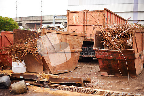 Image of Recycle, metal and rust on skip in junkyard for sorting, garbage and scrap reuse at landfill site. Steel, iron and industrial bin for truck with urban pollution at waste dump with machine