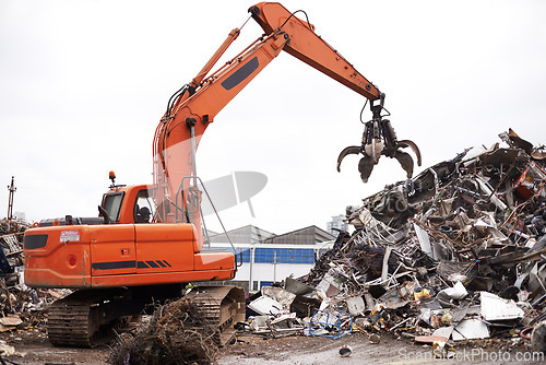 Image of Crane, vehicle and junkyard to recycle metal with sustainability, manufacturing and stop pollution. Machine, tractor and scrapyard for ecology at plant with iron, steel and industry in environment