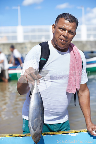 Image of Portrait, sea and fisherman with fish on boat in nature outdoor to travel in summer. Person, man or animal at ship in ocean, food or fresh catch with face of serious angler working by water in Brazil
