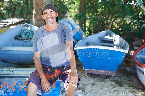 Image of Portrait, man and fisherman on boat by beach outdoor in summer or smoking cigarette in nature. Fishing, mature person and worker by ship at seaside or sailor on transportation for travel in Australia