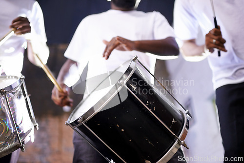 Image of Hands, drum or festival with a band playing an instrument in a carnival in Rio de Janeiro, Brazil. Night show, person or party with a musician, performer or artist banging to create a beat or rhythm