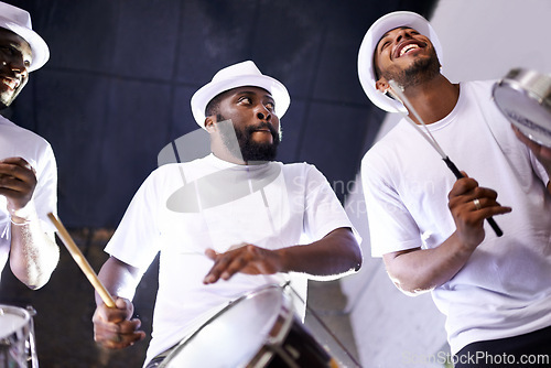 Image of Band, drums or carnival with a happy people playing an instrument in a festival in Rio de Janeiro. Brazil, show or group of musician, performer or artist banging on a drum to create a beat in party