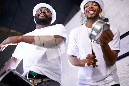 Image of Show, drums or happy band in carnival playing an instrument in festival in Rio de Janeiro. Brazil, low angle or group of musicians or artists banging on a drum to create a beat in party performance