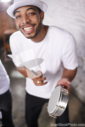 Image of Happy, man and music on drums for carnival, festival or performance with band at party. Night, club and musician smile in portrait with instrument for playing creative samba or salsa beat with rhythm