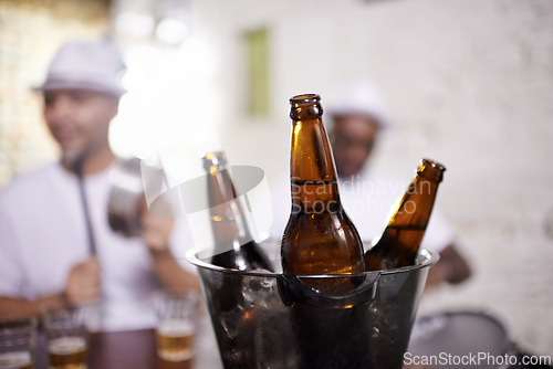 Image of Beer, bottle and musician in performance at club on drums for carnival, festival or party. Night, club and event with alcohol closeup with people with creative energy, samba or salsa beat with rhythm