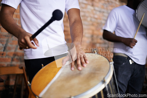 Image of Hands, drum or carnival with a person playing an instrument in a festival in Rio de Janeiro, Brazil. Closeup, band or party with a musician, performer or artist banging to create a beat or rhythm