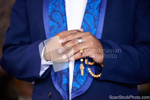Image of Worship, praying or hands of man with rosary for God, faith or belief for support or hope in Christian religion. Closeup, priest or person with prayer beads for spiritual healing, praise or trust