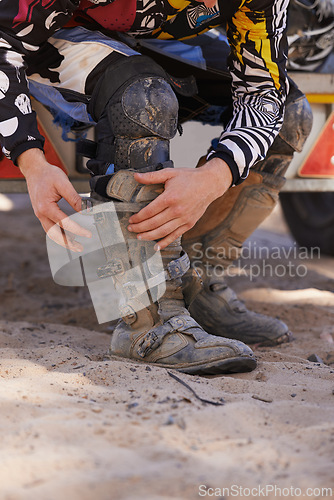 Image of Hands, boots and motorbike with person getting ready for competition, race or training closeup. Exercise, fitness and sports with athlete outdoor in preparation of off road action or performance