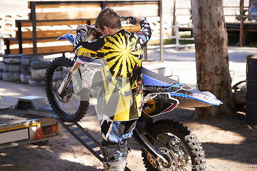 Image of Motorcycle, man and sport for outdoor training, competition and adventure on trailer. Extreme sports, adrenaline and motorbike of young male person, athlete or biker in Minneapolis with back view.